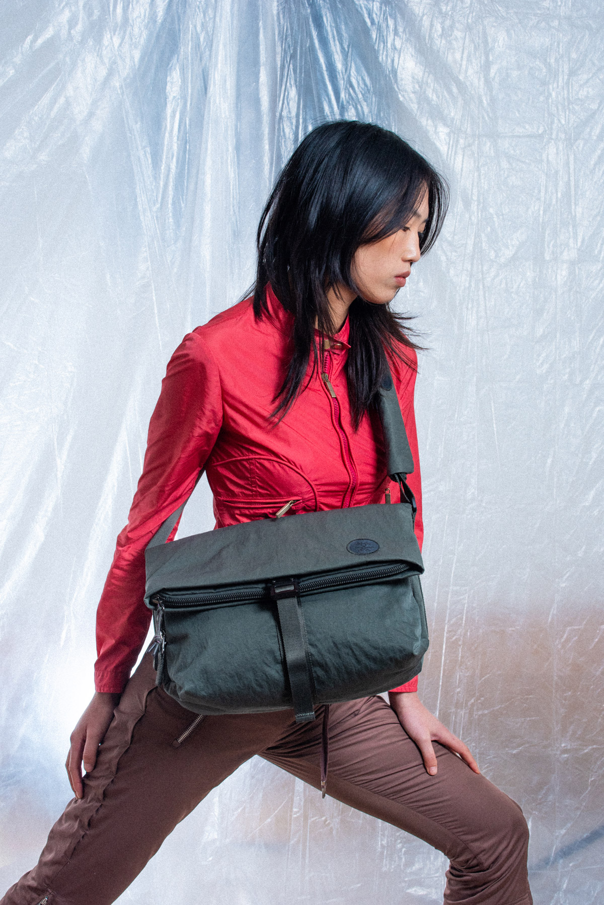 Model in red jacket with dark green KONBU bag